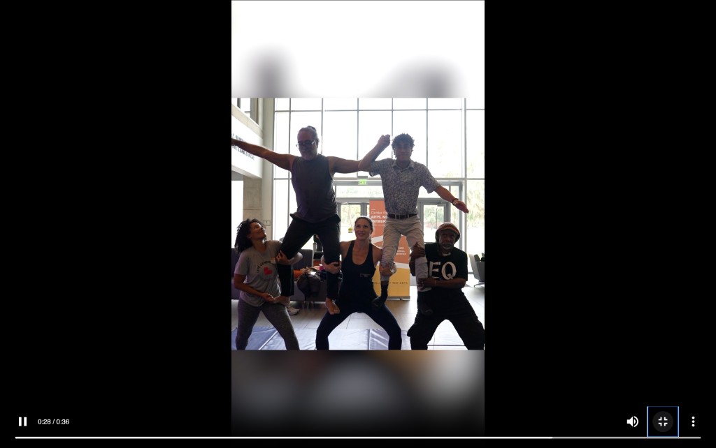 Still from Hybrid Intelligences Highlights: five people in a shared acrobatic balance in the Wertheim lobby.